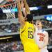 Michigan sophomore Jon Horford takes the ball to the hoop over Florida senior Erik Murphy during the second half at Cowboys Stadium on Sunday, March 31, 2013. Melanie Maxwell I AnnArbor.com